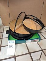 Overall view of stacked cast iron pots with wooden lids and grill pan