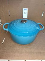 Full view of blue Le Creuset Dutch oven with lid on