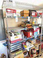 Full view of chrome wire shelving with four shelves and various contents (contents excluded)