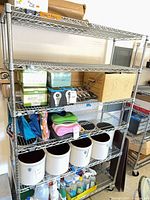 Full view of chrome wire shelving unit with five shelves and casters