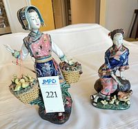 Both figurines side by side on table