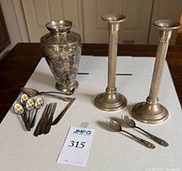 All items: weighted candlesticks, plated vase, flatware