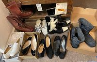 Group shot of all seven pairs of footwear in boxes and on floor