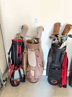 overview of three loaded golf bags