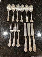 Group shot showing all 11 pieces: 5 spoons, 3 forks, 3 knives