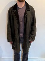 Front view of black shearling coat on model