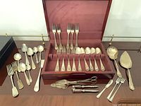 Overall lot showing open flatware box with forks, spoons and assorted serving pieces