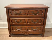 Front view showing three drawers, hardware and overall style