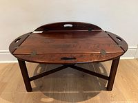 Coffee table front perspective showing fold-down tray sides and base