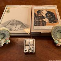 Overview of stationery items, ceramic frames and metal box