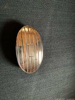 Top view showing striped sterling silver surface and monogram