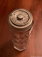 Top view showing sterling silver perforated lid with central button