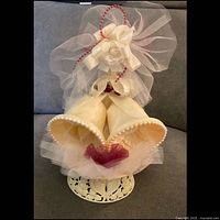 Front view showing bells, base, tulle, bead arch and rose