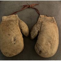 Front view of both gloves showing leather surface wear