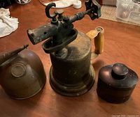 Three vintage metal items lined up on table