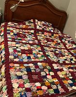 Quilt displayed on double bed showing overall size and colour layout