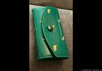 Front view of closed green leather key case