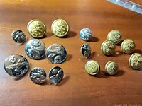 Group view of all 16 buttons showing both designs and sizes