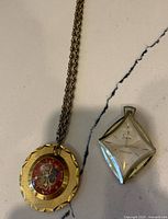 Both pendant watches showing overall forms