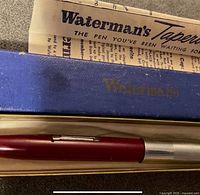 Blue Waterman’s box with brand logo and burgundy pen inside