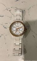 Front view of white Fossil watch showing dial and bracelet