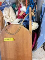 Wooden sled, racquets, doll and accessories in bin