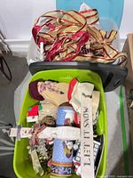 Two plastic bins with assorted Christmas décor visible