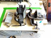 Overview of both vises and C-clamp on workbench
