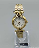 Front view of Caprice by Timex gold-tone stretch watch on display stand