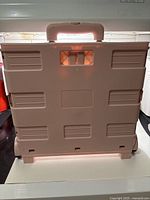 Trolley folded showing rear panel and carry handle