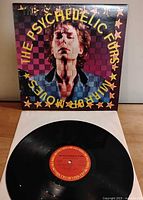 Front album jacket with vinyl on white sleeve