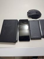 Group shot showing Kindle in cover, three smartphones and gaming mouse