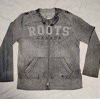 Front view showing printed zipper, pockets, logo