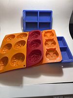 Group of five silicone molds in assorted colors and shapes
