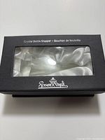 Closed black Rosenthal box with window displaying crystal stopper