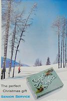 Full view of advertisement showing snowy landscape, skier, cigarette pack, caption
