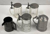 Group shot of jug, tankard and three glass steins
