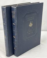 Two navy hardcover volumes standing upright