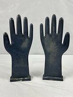 front view of both ceramic glove molds standing upright