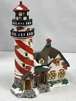 Full view of porcelain lighthouse and cottage building