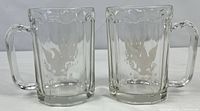 Front view of both glass mugs showing etched eagle design
