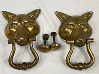 Both brass fox door knockers with strike posts displayed
