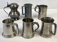 Group shot of six pewter vessels
