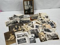 Overview of entire lot showing framed photo and loose vintage prints