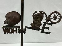 Right side detail with horse figure, wheel, and letter "E"