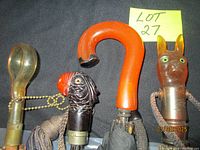 Four umbrella handles lined up, showing overall forms