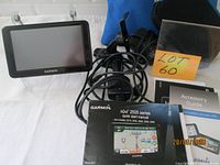 Full lot showing GPS unit, accessories, manuals, blue pouch