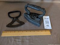 Pastry cutter, sad iron and ruler for scale