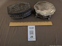 Both jewelry boxes beside ruler for scale