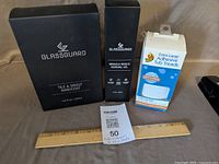 All three boxed items with ruler for scale